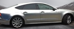 Split image showing a car with half silver matte wrap and half painted surface for visual comparison